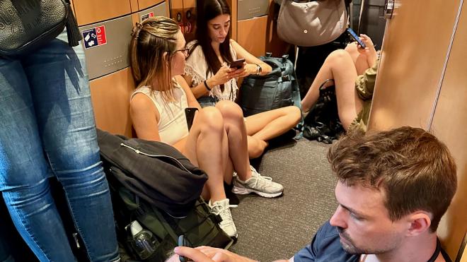 People sitting on a train floor