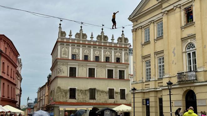 &ldquo;a man walking a highline strung between buildings&rdquo;