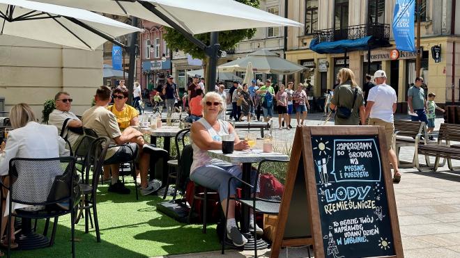 &ldquo;Karen seated outdoors at a restaurant with a pedestrian street behind her&rdquo;